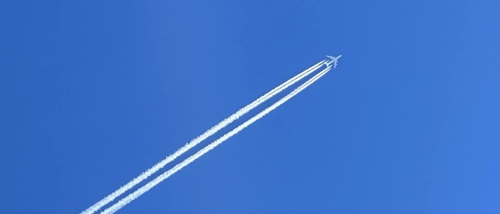 A commercial airplane gliding through a clear blue sky
